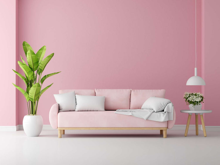 Light pink-painted dining room walls with a long wooden table, matching chairs and bench seating.