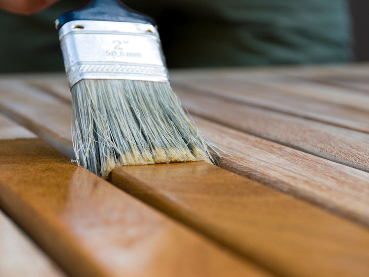 Top down view of striped blue shoes and chair with blue pillow on wooden deck